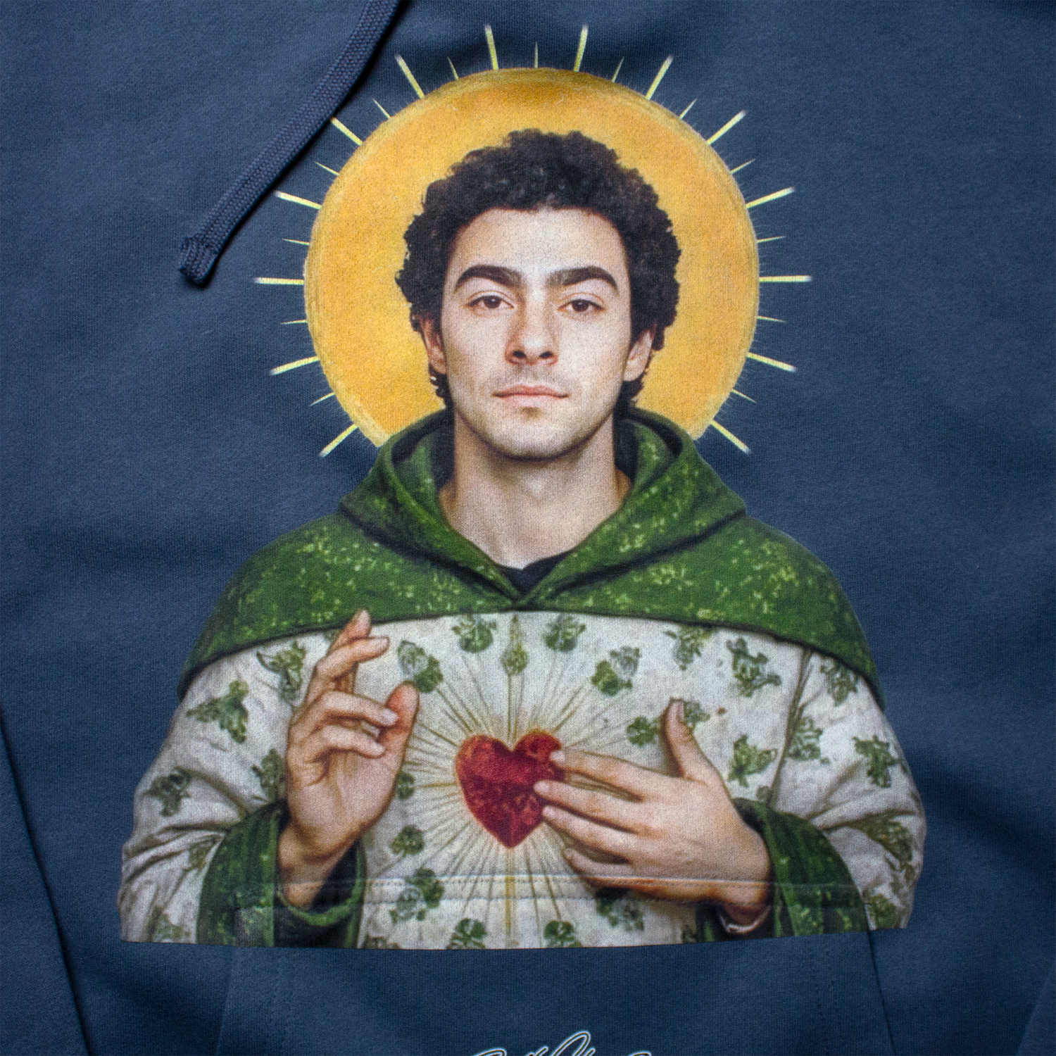 Close-up of Luigi Mangione print featuring golden halo, green robe, and glowing heart design